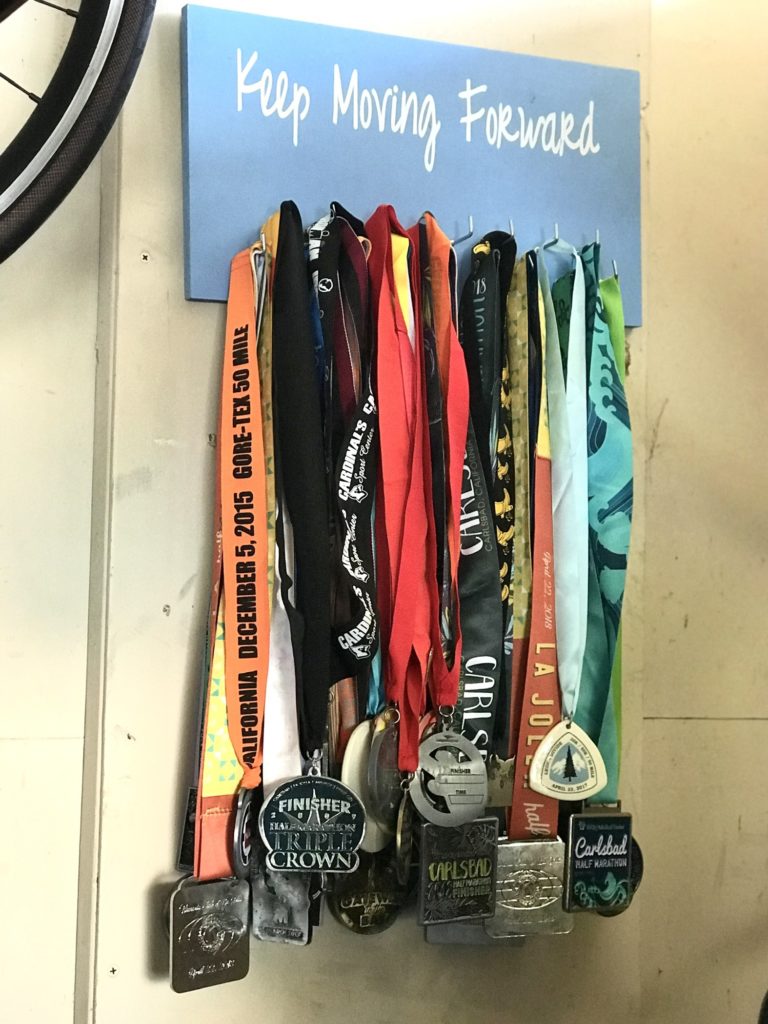hanging race medals on a board